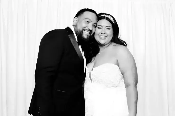 Happy client glam photo booth in Fresno wedding with white sequin backdrop 1