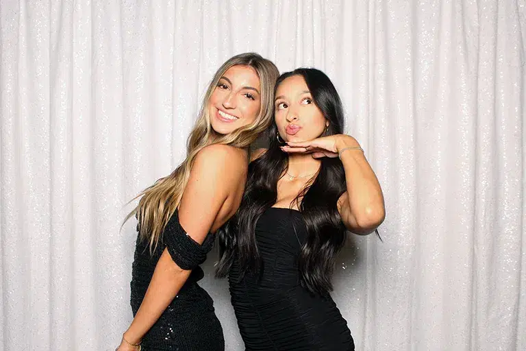 Open air photo booth at Fresno private party with white sequin backdrop.